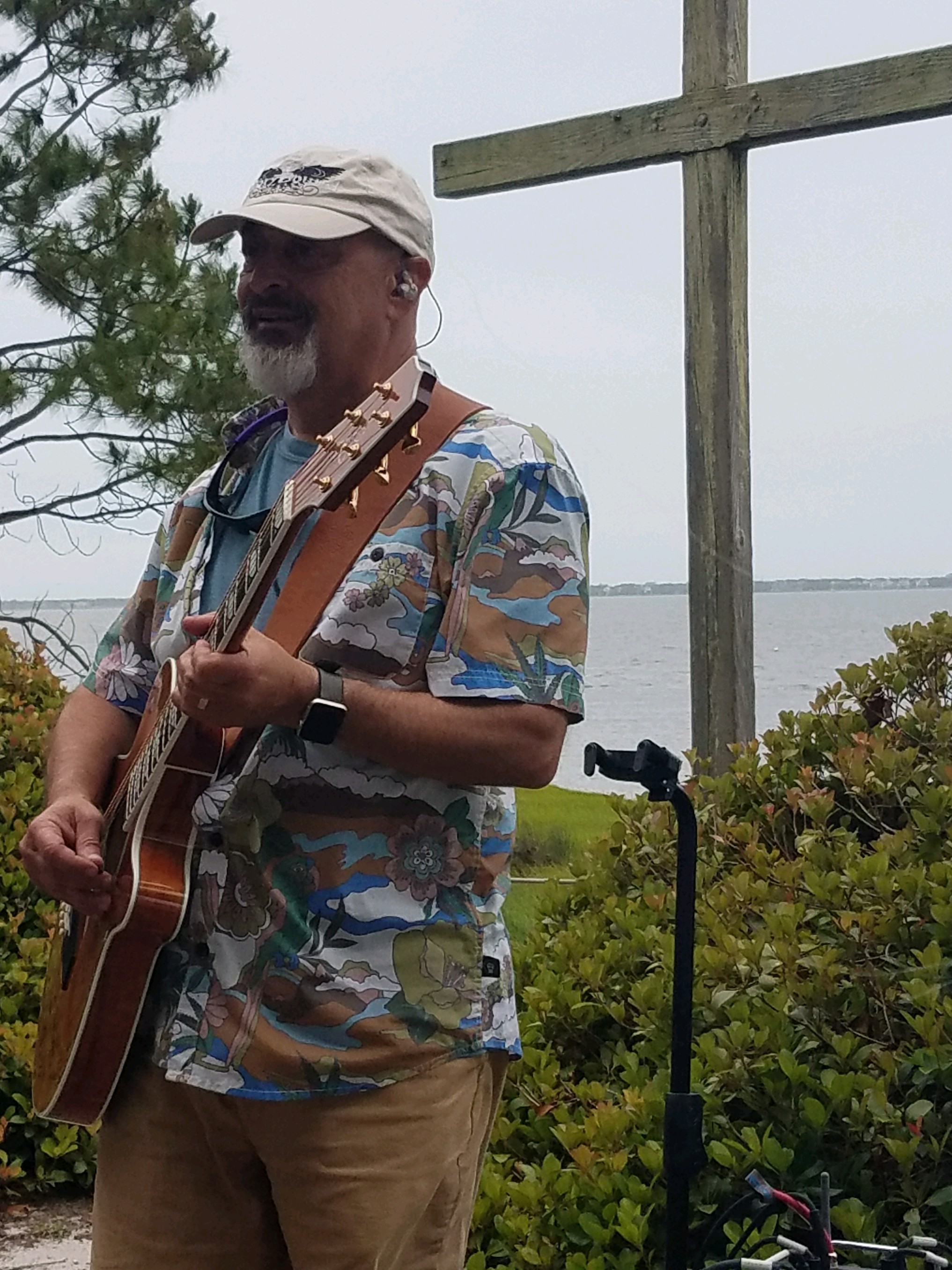 Jim leading worship with an acoustic guitar.