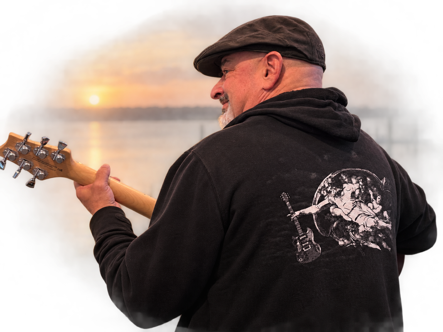 Jim wearing a sweatshirt with God handing down a guitar.